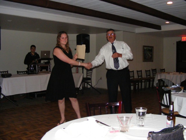 Katiy recieving 5 year service pin. Banquet 2009