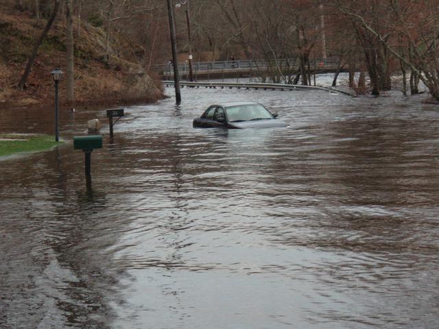 One of many vehicles stuck in flood waters that members had to rescue people from. Looking towards the Potter Hill Bridge from the corner of Maxson Street
